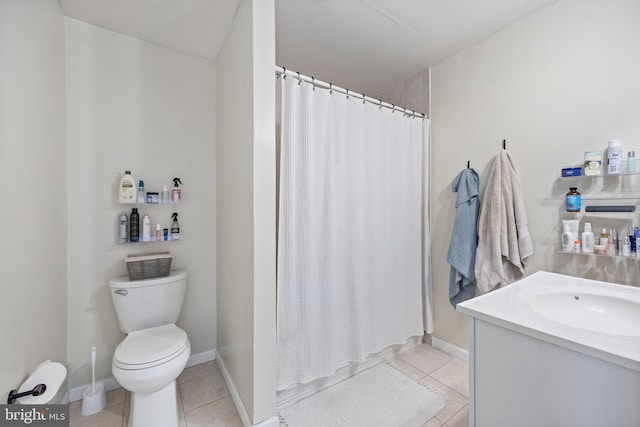 bathroom featuring tile patterned flooring, a shower with curtain, vanity, and toilet