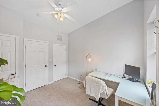 carpeted home office featuring ceiling fan