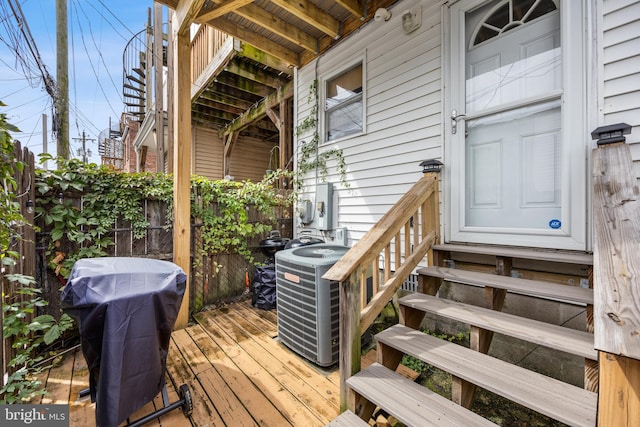 wooden deck featuring cooling unit and grilling area