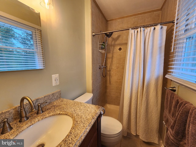 bathroom with walk in shower, vanity, and toilet