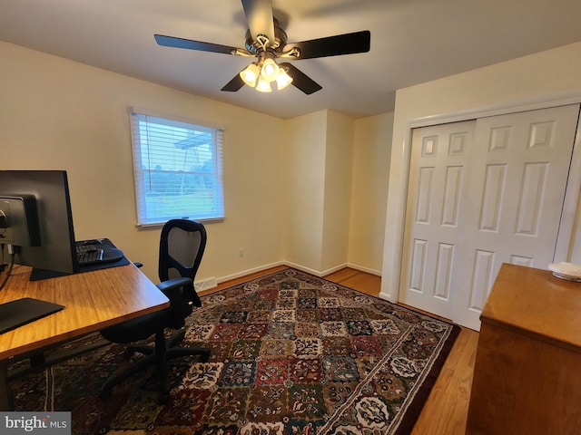 home office featuring hardwood / wood-style floors and ceiling fan