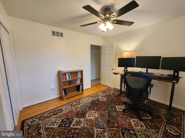 office space with hardwood / wood-style flooring and ceiling fan