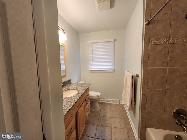 full bathroom with tile patterned floors, vanity, toilet, and tiled shower / bath combo