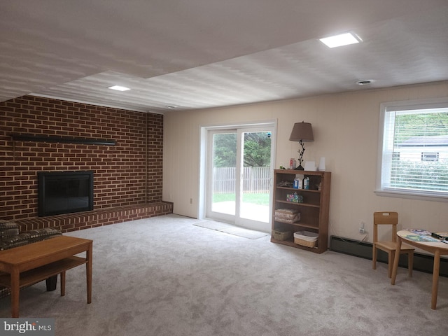 carpeted living room featuring a baseboard radiator and a brick fireplace