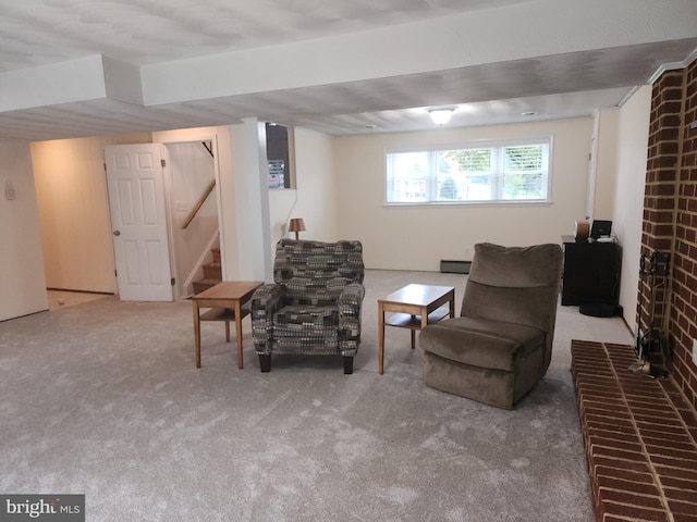 living area with a baseboard radiator, carpet flooring, and a brick fireplace