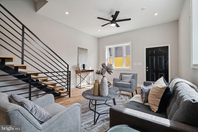 living room with ceiling fan, a healthy amount of sunlight, and light wood-type flooring