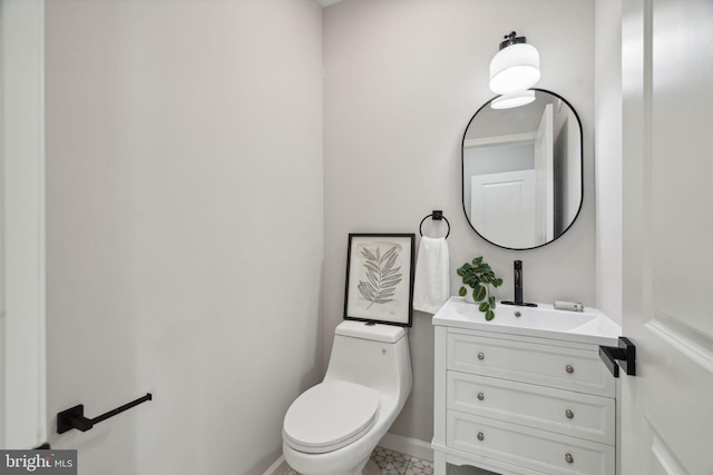 bathroom featuring tile patterned floors, vanity, and toilet