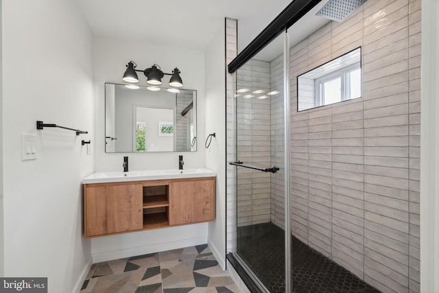 bathroom featuring vanity, an enclosed shower, and a wealth of natural light