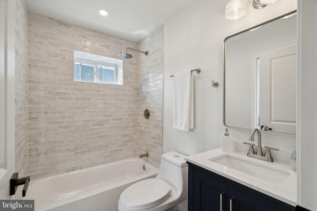 full bathroom featuring vanity, toilet, and tiled shower / bath combo