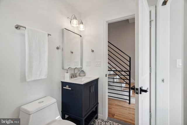 bathroom featuring hardwood / wood-style floors, vanity, and toilet