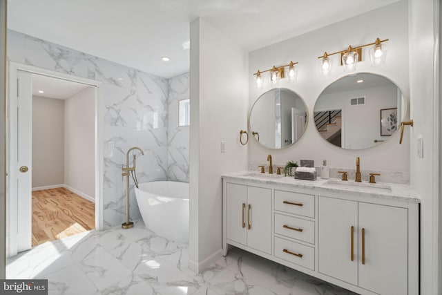 bathroom featuring vanity, hardwood / wood-style flooring, and a bathtub