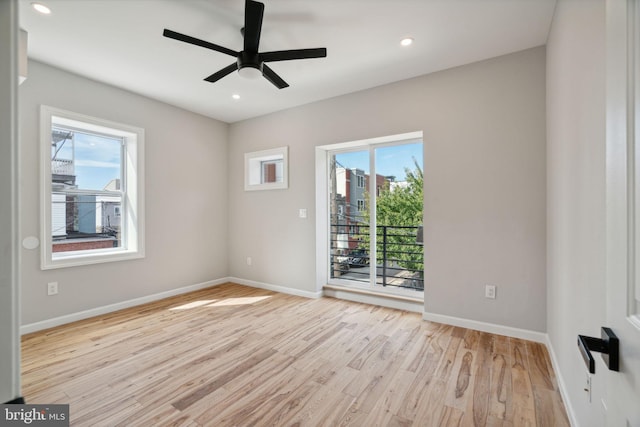 unfurnished room with light hardwood / wood-style flooring, plenty of natural light, and ceiling fan