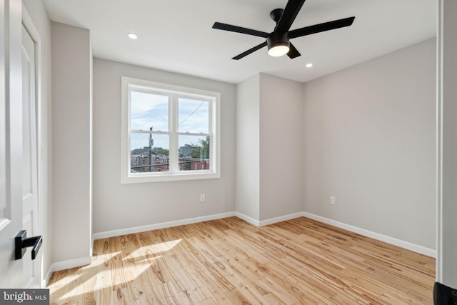 spare room with light hardwood / wood-style flooring and ceiling fan