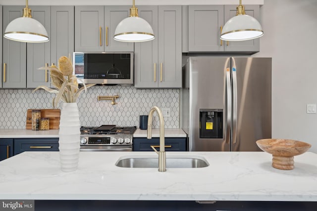 kitchen featuring appliances with stainless steel finishes, tasteful backsplash, gray cabinetry, and sink