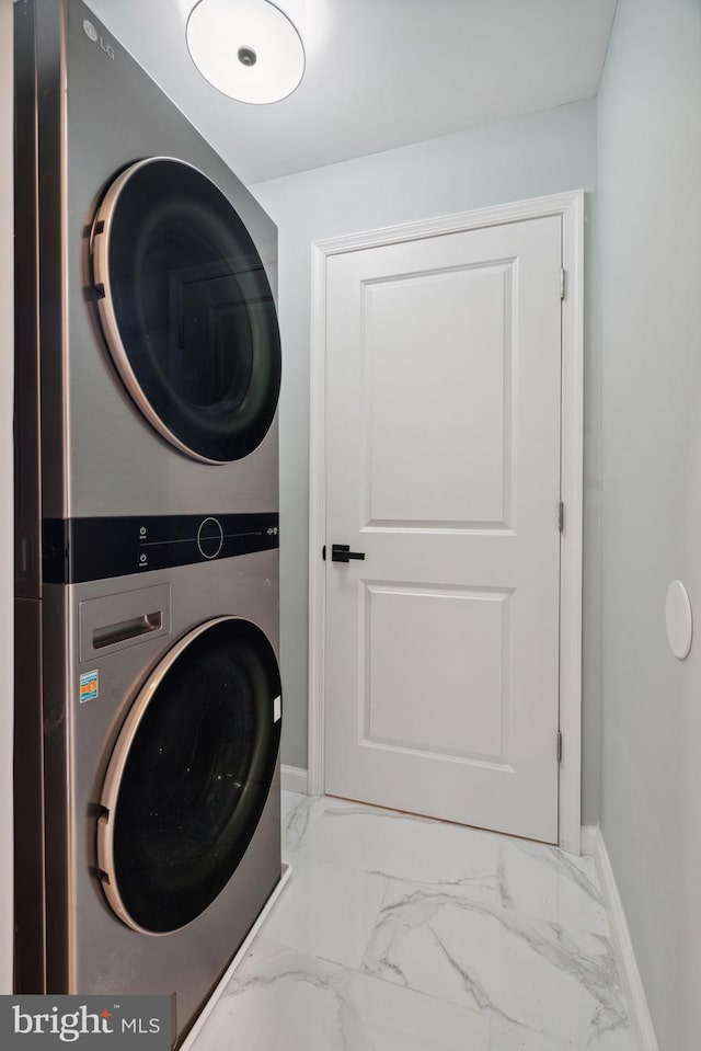 clothes washing area with stacked washer / drying machine