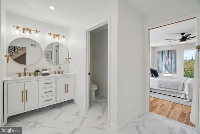 bathroom featuring ceiling fan, vanity, hardwood / wood-style flooring, and toilet