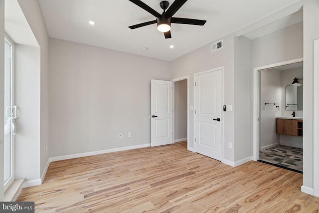 unfurnished bedroom with ensuite bath, ceiling fan, and light hardwood / wood-style flooring