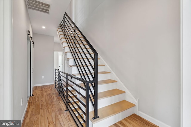 stairs featuring wood-type flooring