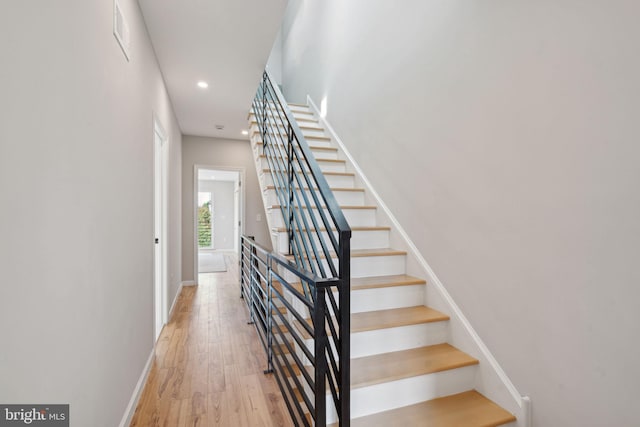 stairs featuring wood-type flooring