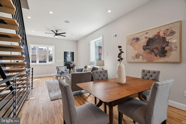 dining area featuring light wood-type flooring and ceiling fan