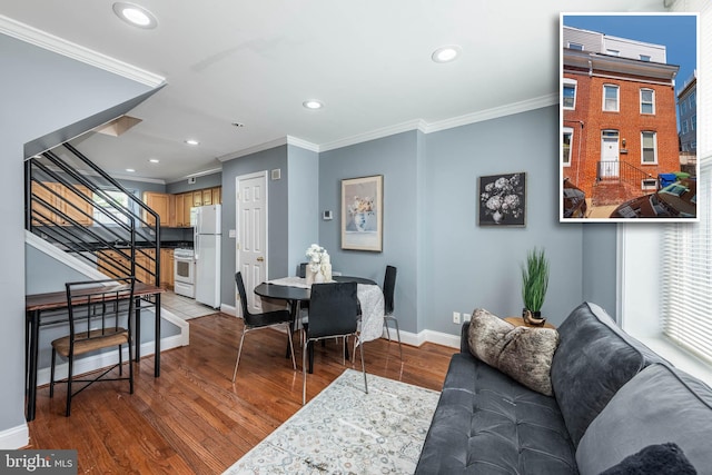 living room featuring wood-type flooring and crown molding