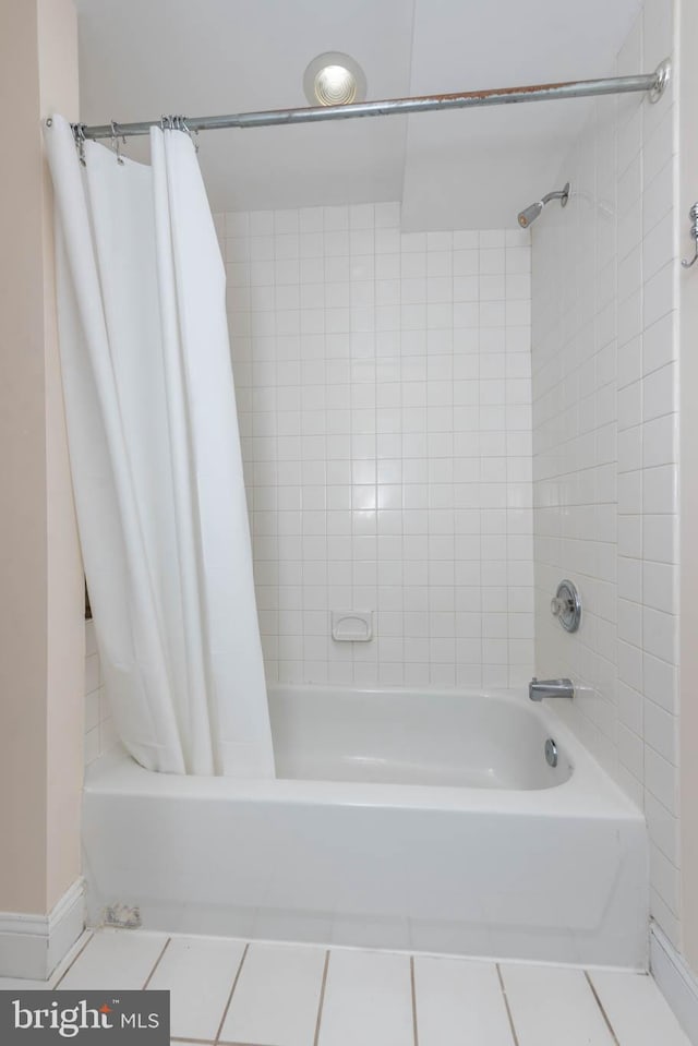 bathroom with tile patterned flooring and shower / bath combo