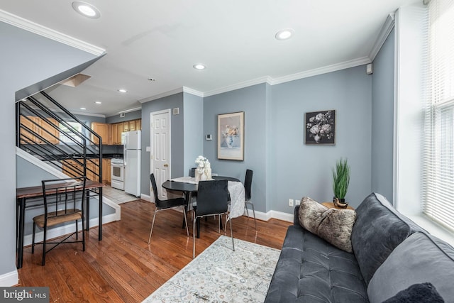 living room with wood-type flooring and ornamental molding