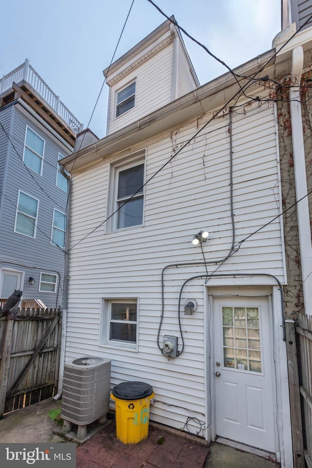 rear view of house featuring central air condition unit