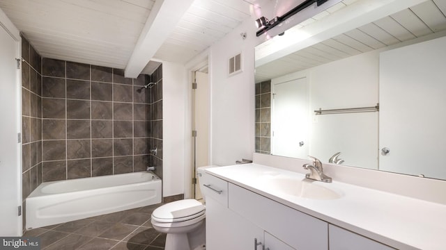 full bathroom featuring vanity, tiled shower / bath combo, toilet, and tile patterned floors