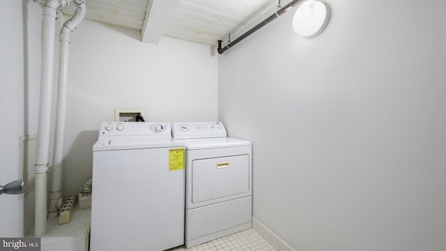 laundry area with wood ceiling, light tile patterned floors, and separate washer and dryer