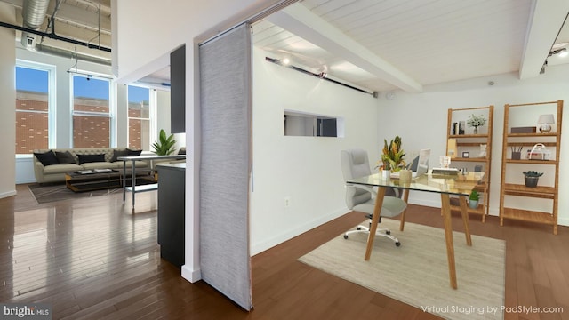 home office with beamed ceiling and dark wood-type flooring