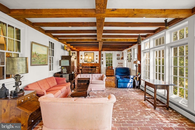 sunroom / solarium featuring beamed ceiling, baseboard heating, and plenty of natural light