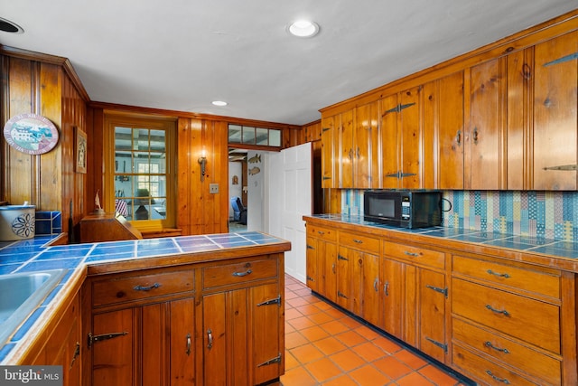 kitchen featuring tile counters, light tile patterned floors, and tasteful backsplash