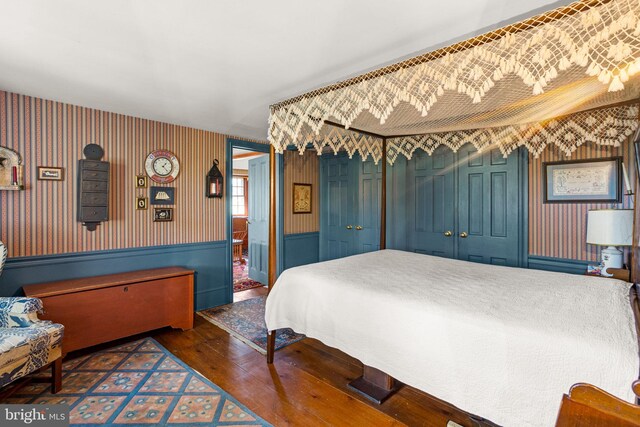 bedroom with dark hardwood / wood-style flooring