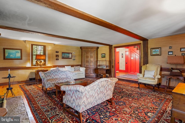 living room with wood-type flooring and beamed ceiling