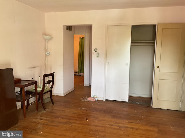 bedroom featuring a closet and dark wood-type flooring