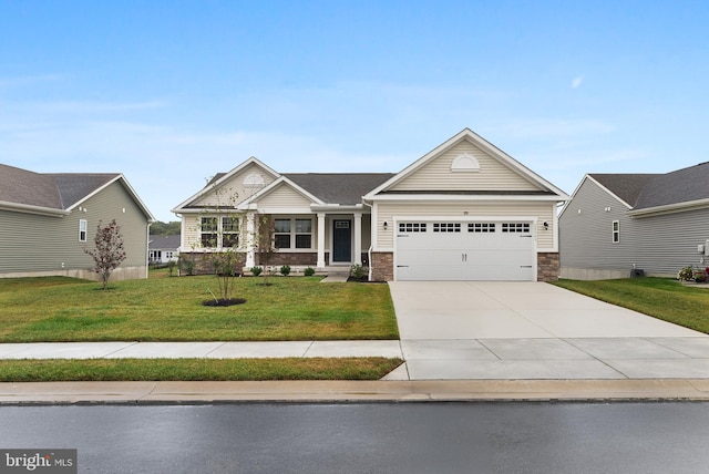 view of front of home with a garage and a front lawn