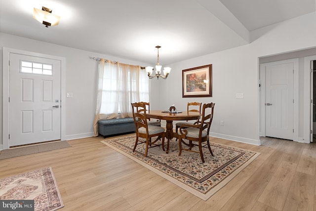 dining room with a chandelier and light hardwood / wood-style floors