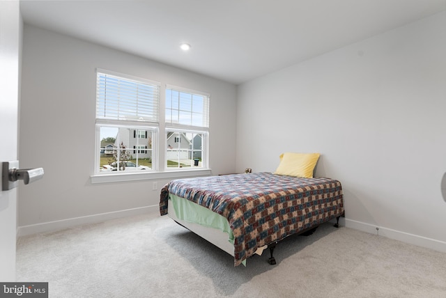 bedroom featuring light colored carpet