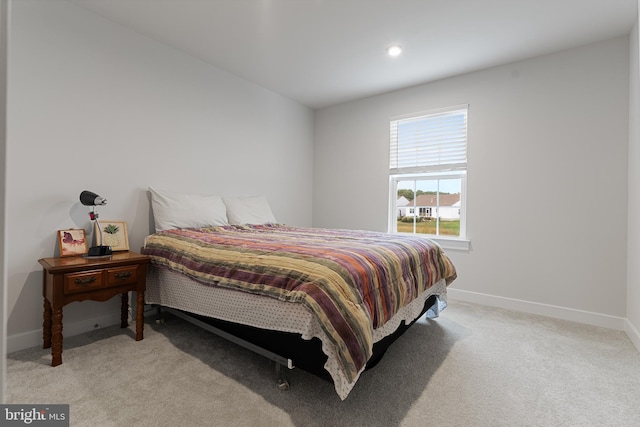 bedroom featuring light carpet