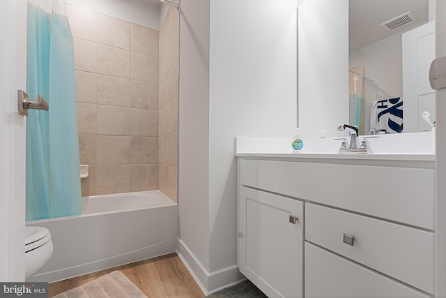 full bathroom featuring toilet, shower / bath combination with curtain, wood-type flooring, and vanity