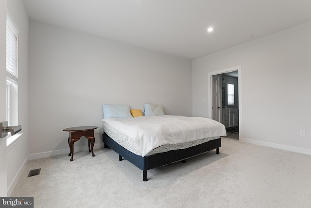 bedroom featuring light colored carpet