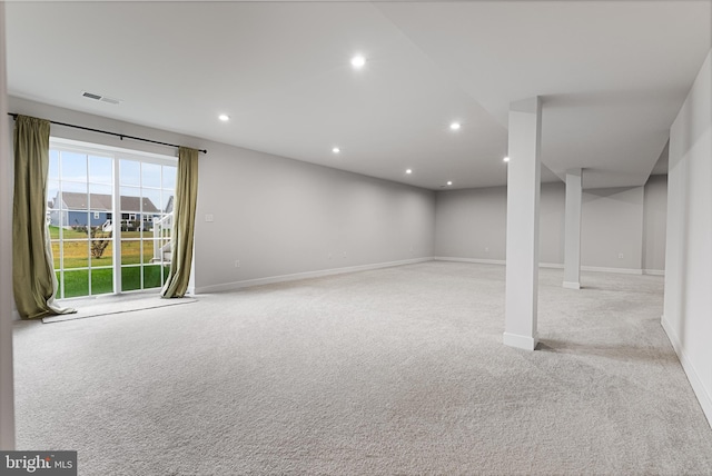 basement featuring light carpet