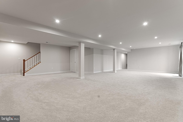 basement featuring light carpet