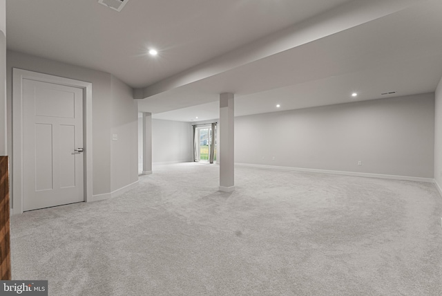 basement featuring light colored carpet