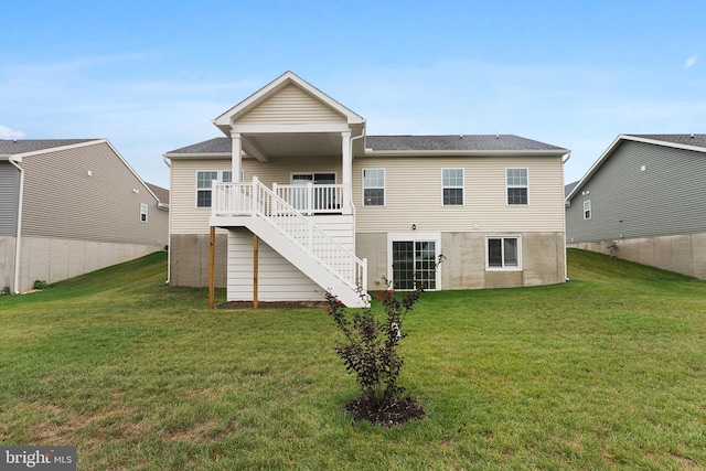 back of property featuring a lawn