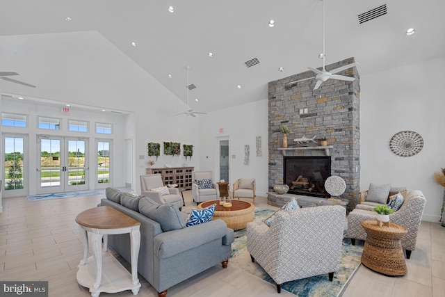 living room featuring high vaulted ceiling, ceiling fan, french doors, and a fireplace