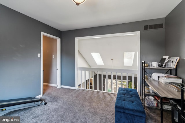 sitting room with a skylight and dark carpet