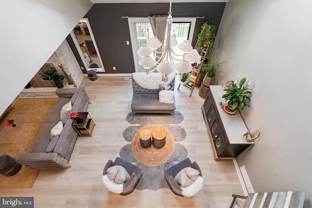 living room featuring light hardwood / wood-style flooring and a notable chandelier