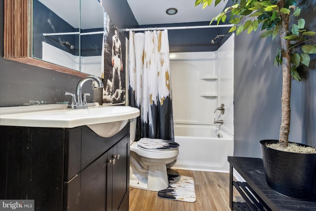 full bathroom featuring vanity, shower / bath combo, wood-type flooring, and toilet